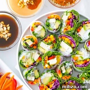 Vietnamese vegetarian summer rolls with rainbow veggies with peanut sauce, hoisin sauce, and dipping sauce