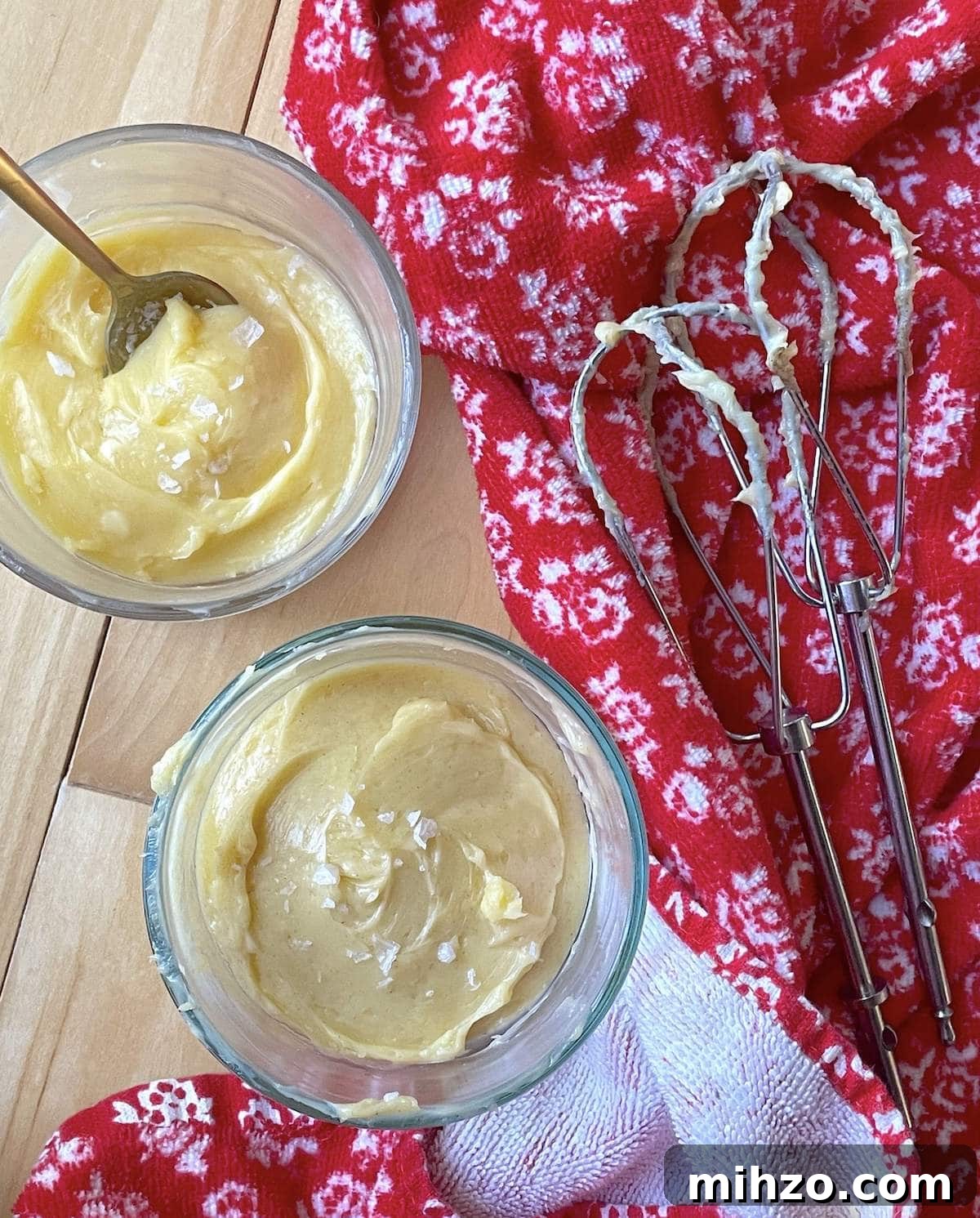 Whipped Honey Butter Recipe: Smooth, Spreadable & Quick 2 Two small bowls of honey butter next to two beaters with a red towel.