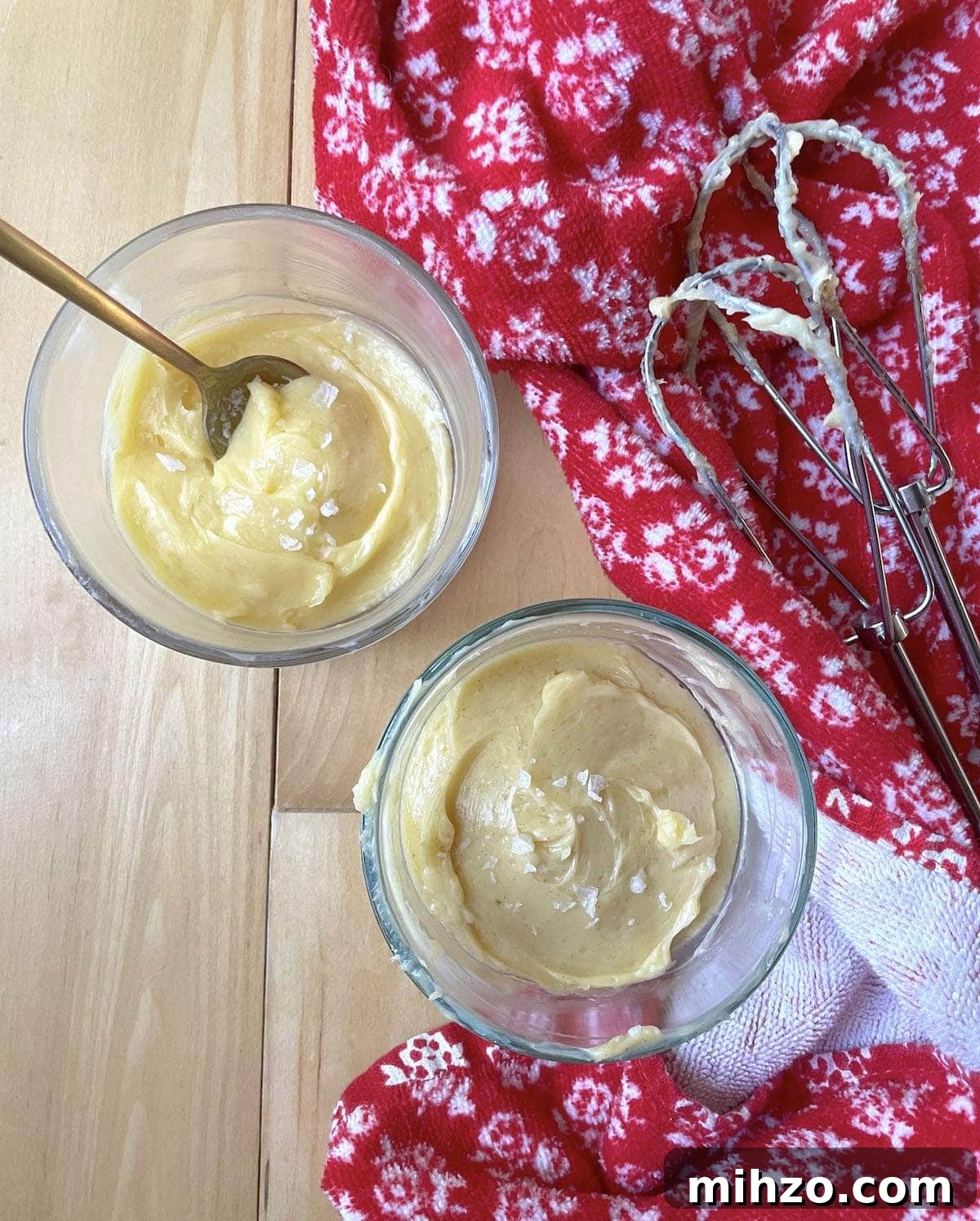 Whipped Honey Butter Recipe: Smooth, Spreadable & Quick 14 Two small bowls of honey butter next to two beaters with a red towel.