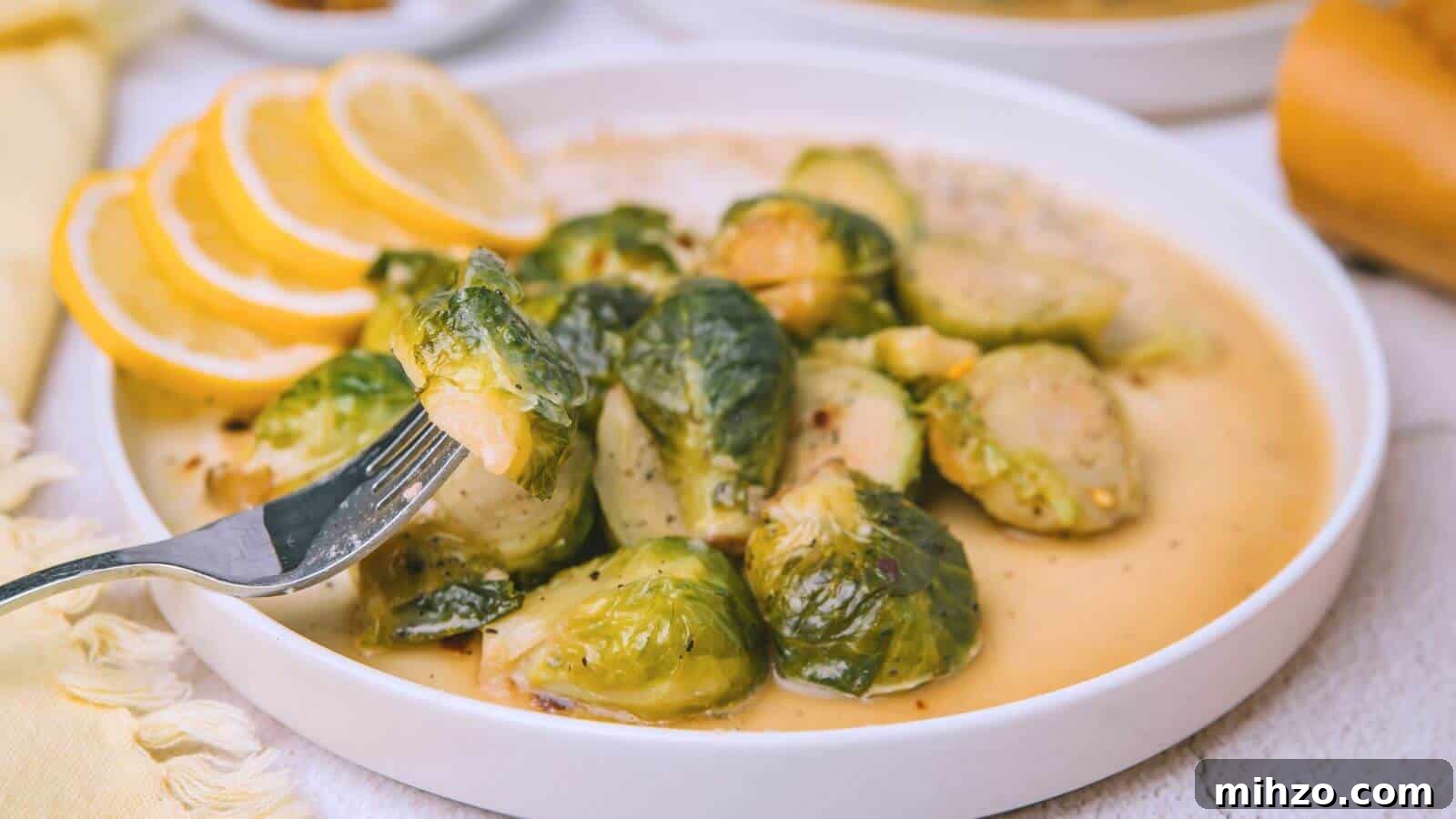 24 Brussels Sprouts Recipes That Even Non-Veggies Will Love 8 A plate of cooked Brussels sprouts in sauce with lemon slices on the side. A fork holds one sprout above the plate.