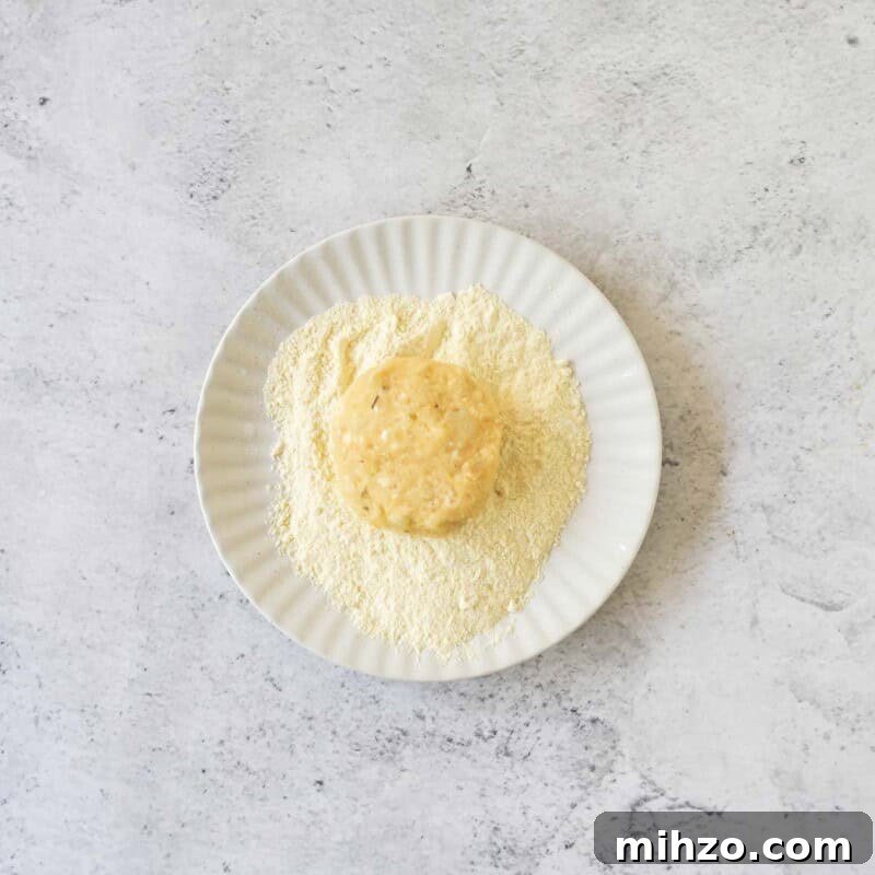Crispy Potato Fritters Recipe — Golden Pan-Fried Latkes 6 Coat each of the patties using the remaining cornmeal.