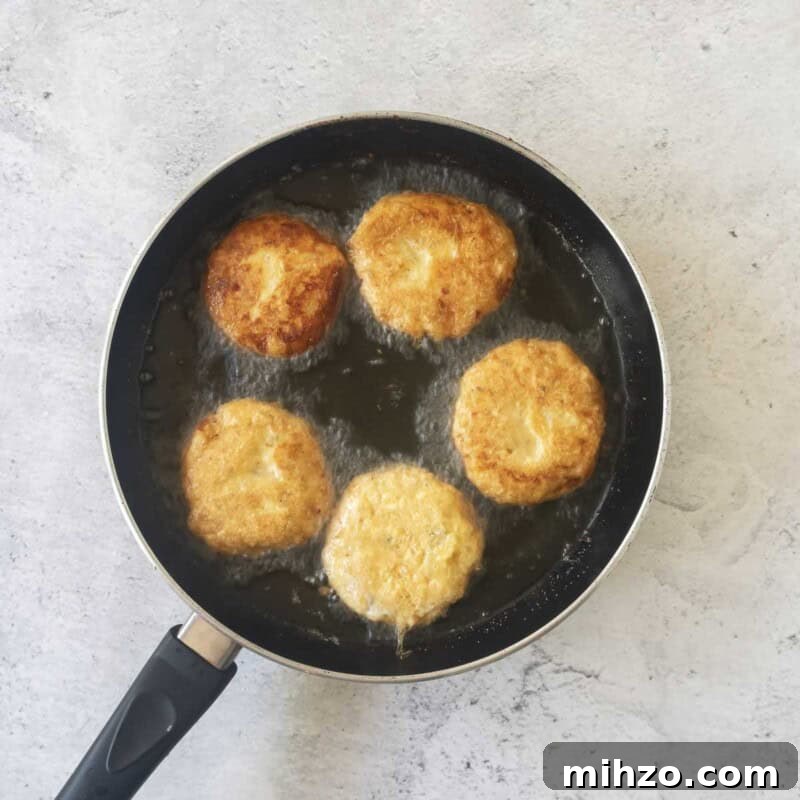 Crispy Potato Fritters Recipe — Golden Pan-Fried Latkes 7 Fry potato fritters in about ¼ inch of vegetable oil until golden brown and crispy.