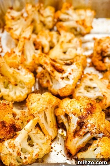 Smoked cauliflower florets in an aluminum pan.