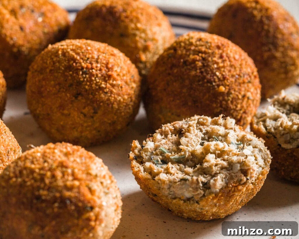 A close-up of fried boudin balls on a light background.