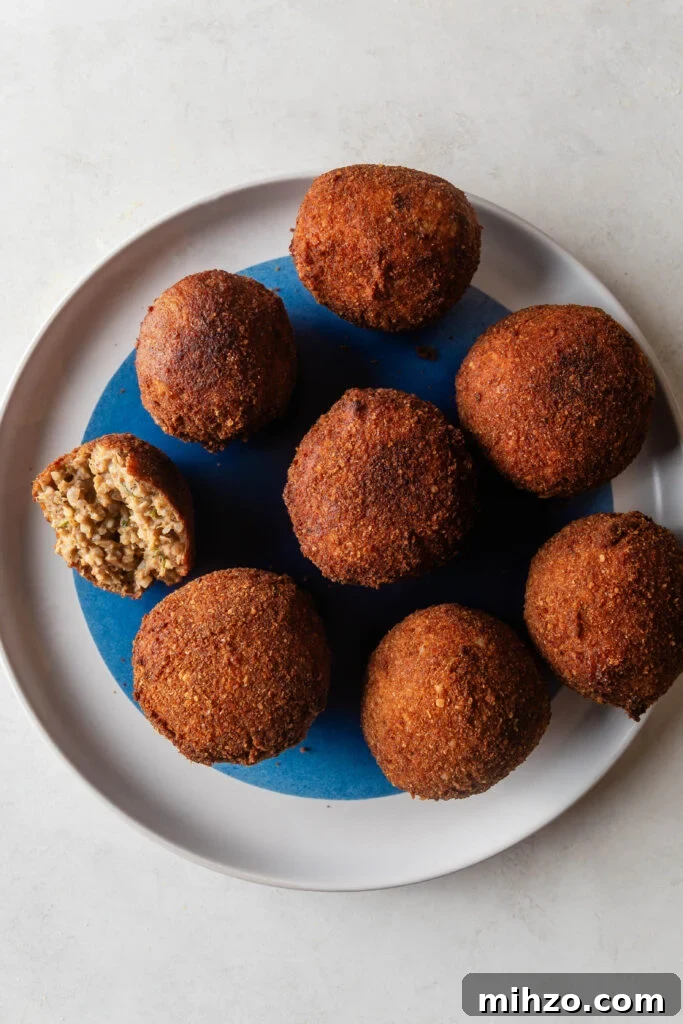 fried boudin balls on a white and blue plate
