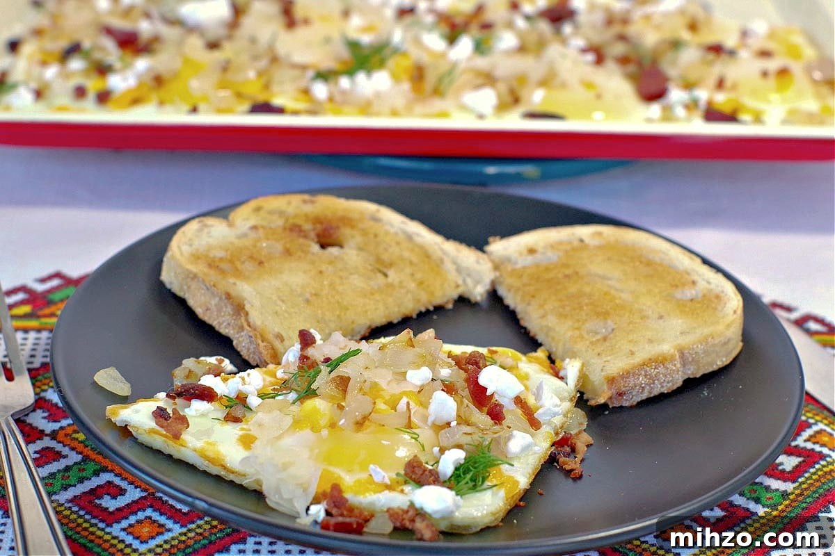 Ukrainian-Style Baked Eggs: Hearty Dinner Recipe 13 Sheet pan Ukrainian style eggs on plate with eggs on sheet pan in background