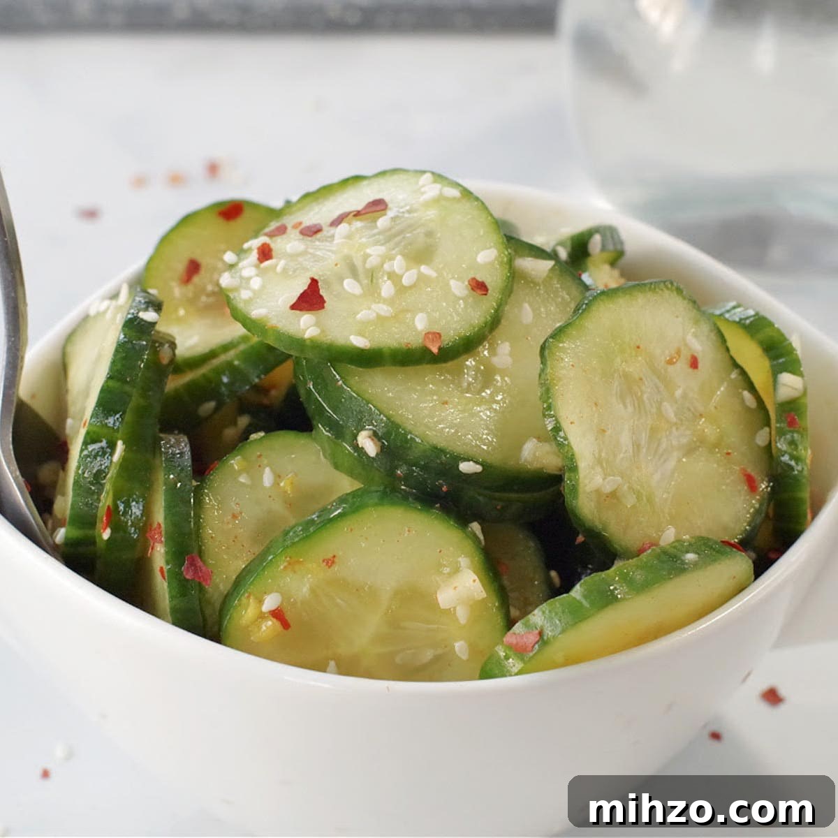 Ukrainian-Style Baked Eggs: Hearty Dinner Recipe 15 kimchi pickle in white bowl on grey marble counter surface with glass vinegar container in background