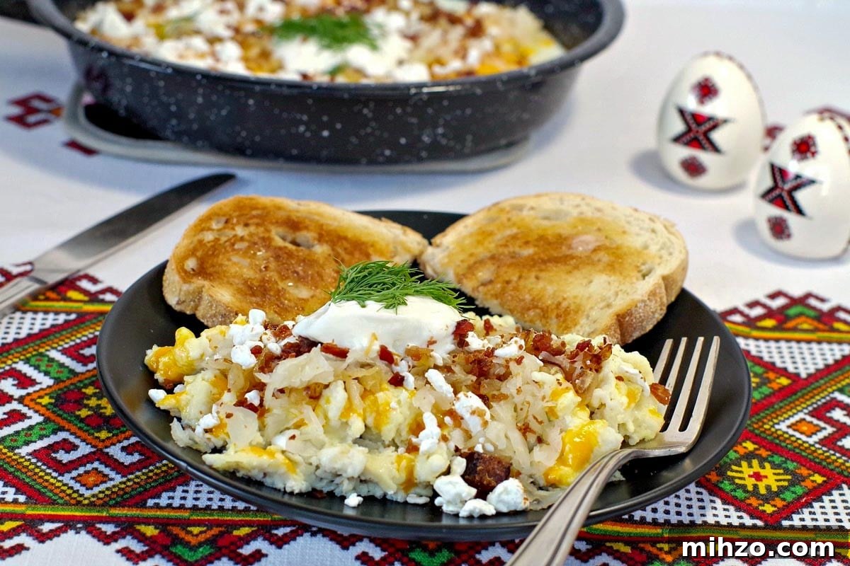 Ukrainian-Style Baked Eggs: Hearty Dinner Recipe 4 Scrambled Ukrainian style eggs on a black plate in foreground with pan of fried Ukrainian style eggs in background
