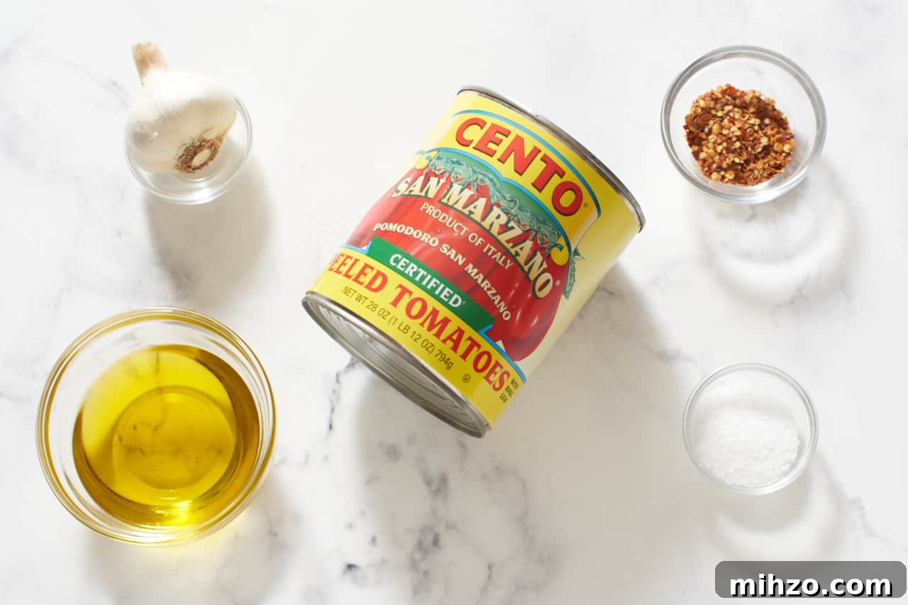 Authentic San Marzano Tomato Sauce Recipe for Rich Flavor 3 A can of San Marzano tomatoes, and four small glass bowls with olive oil, garlic, crushed red pepper and kosher salt.