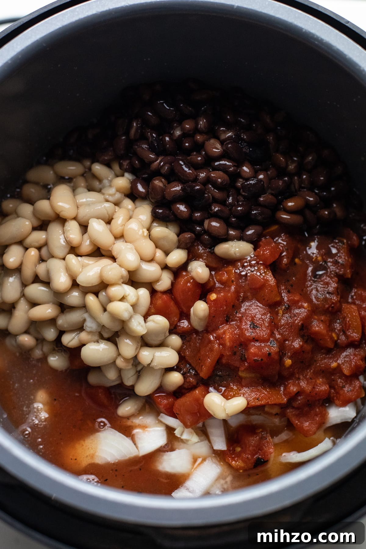 Slow-Cooker Chicken Chili Recipe for Cozy Weeknight Meals 4 A slow cooker pot with ingredients for chicken chili in it.
