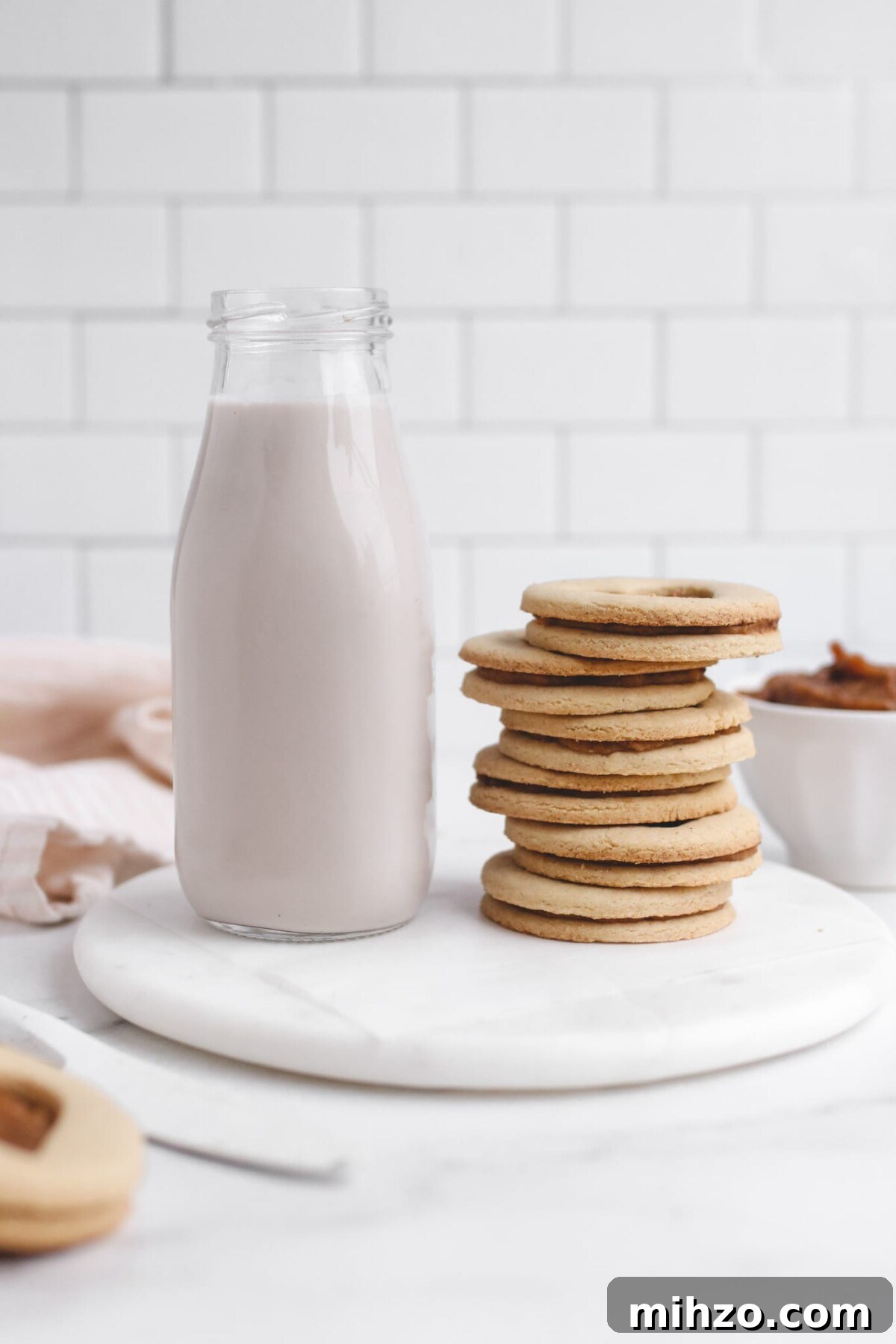 Vegan Gluten-Free Salted Caramel Cookie Recipe 3 a stack of salted caramel cookies next to a glass of milk