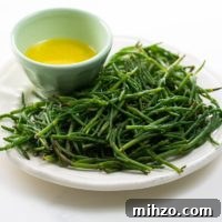 How to Cook Sea Beans (Samphire) — Simple Salicornia & Glasswort Recipe 7 sea beans on a plate with a bowl of lemon butter for dipping