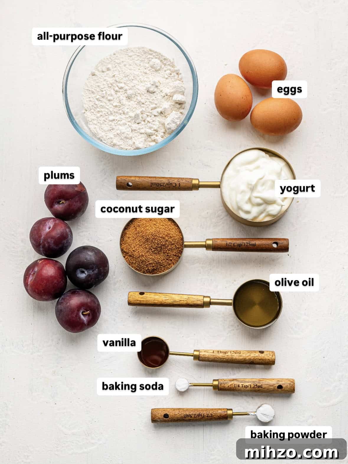 Ingredients for yogurt plum cake on a counter top.