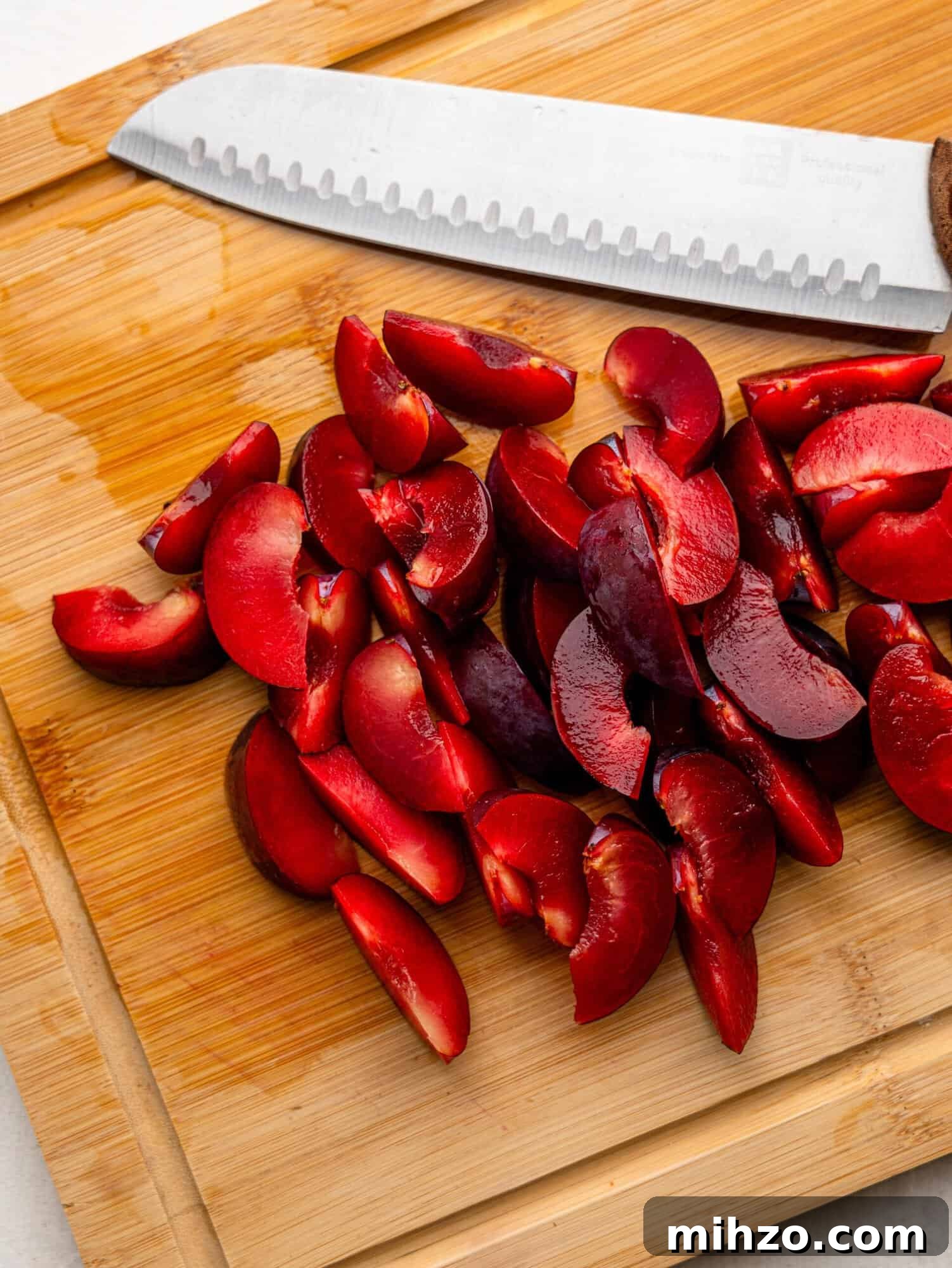 Sliced plums on a chopping board.