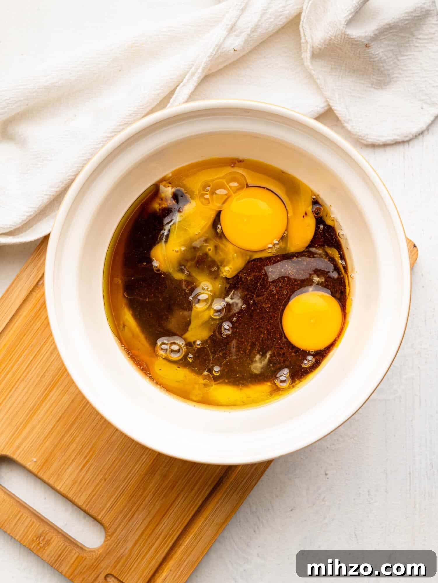 Yogurt, coconut sugar, olive oil, vanilla extract and eggs in a mixing bowl.