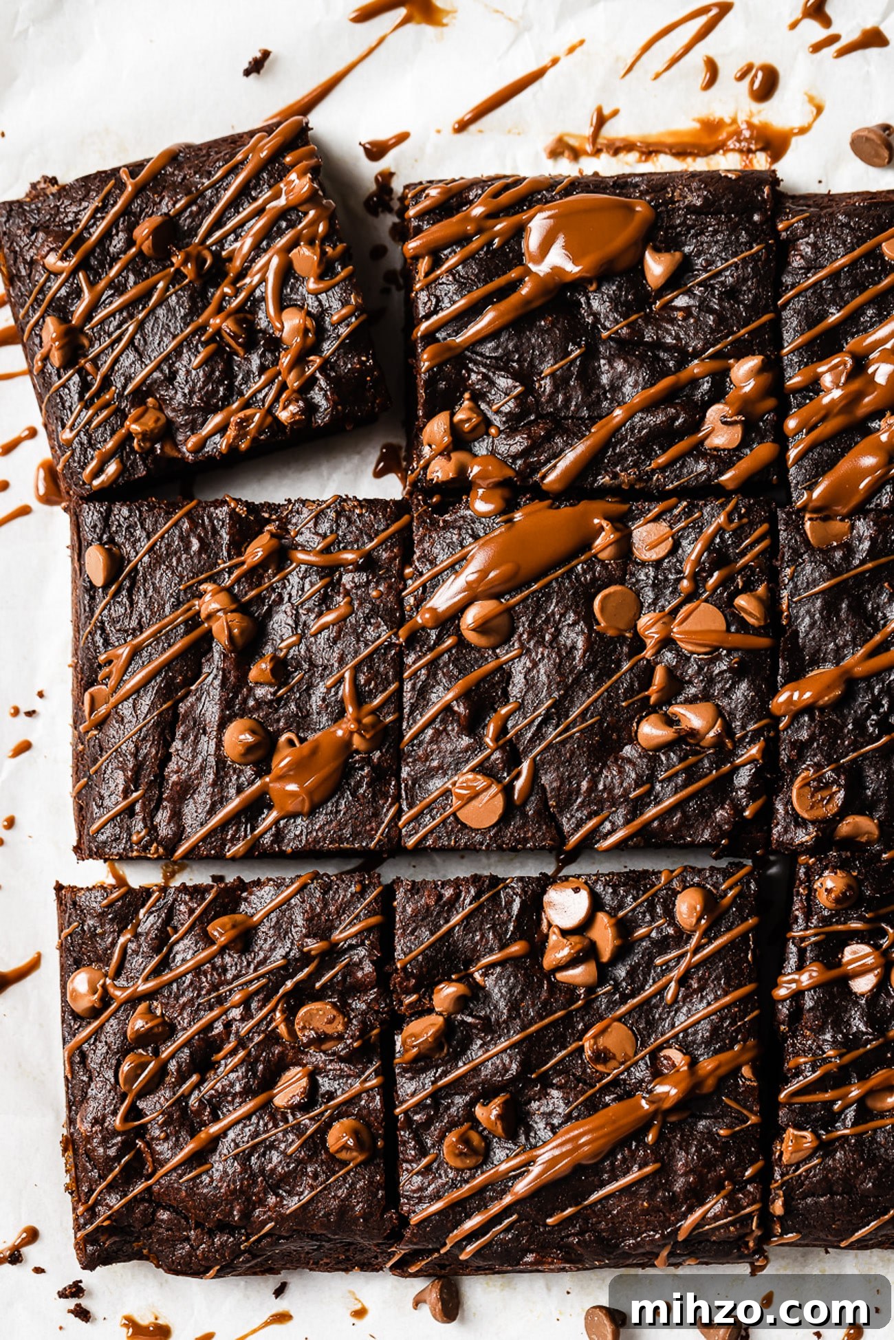 Fudgy Pumpkin Brownies with Warm Spice Flavor 11 Healthy pumpkin brownies cut into squares and drizzled with chocolate.
