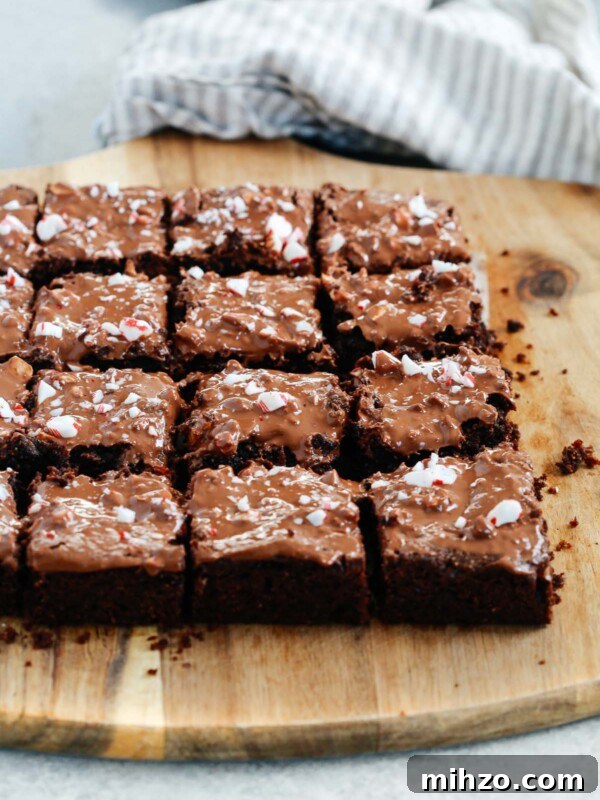 Fudgy Pumpkin Brownies with Warm Spice Flavor 13 Angled photo of multiple gluten-free Peppermint Brownies cut on a serving board.