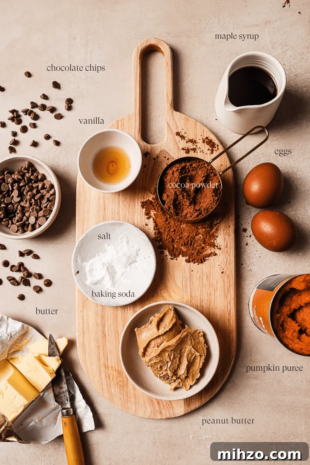Fudgy Pumpkin Brownies with Warm Spice Flavor 3 An overhead view of pre-measured ingredients on a wooden cutting board.
