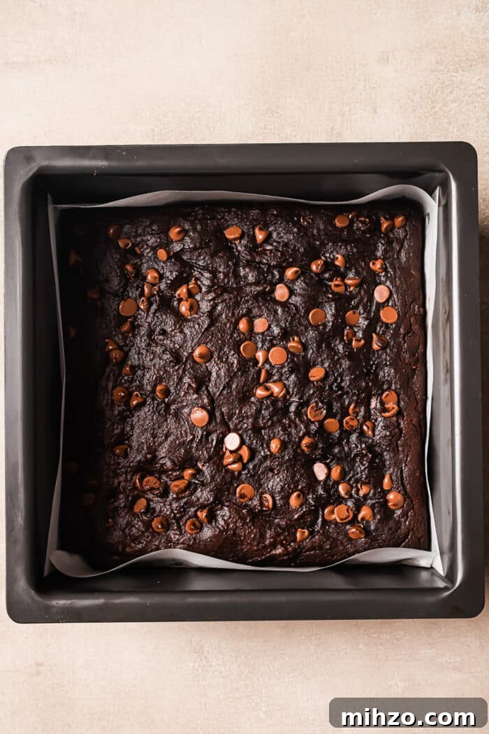 Fudgy Pumpkin Brownies with Warm Spice Flavor 7 An overhead view of healthy pumpkin brownies in a square baking dish.