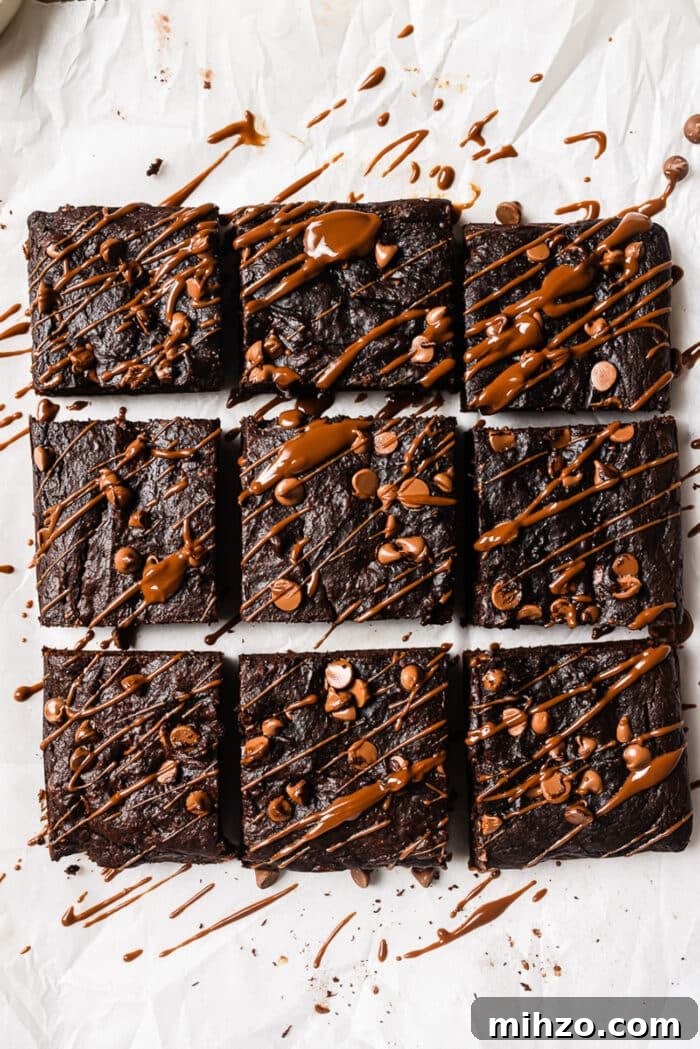 Fudgy Pumpkin Brownies with Warm Spice Flavor 9 Healthy pumpkin brownies drizzled with chocolate sauce.