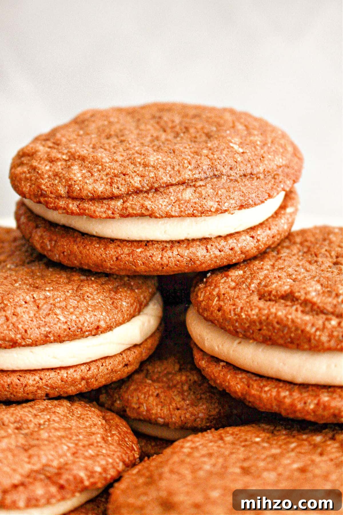Gingerbread Sandwich Cookies Recipe for the Holidays 2 Close up pile of gingerbread sandwich cookies. Light gray background.