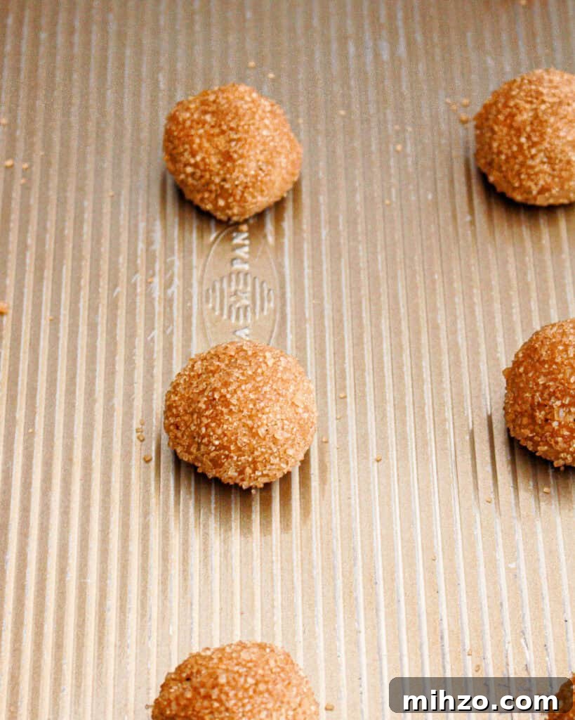 Gingerbread Sandwich Cookies Recipe for the Holidays 6 Metal cookie sheet with gingerbread cookie balls before baking.