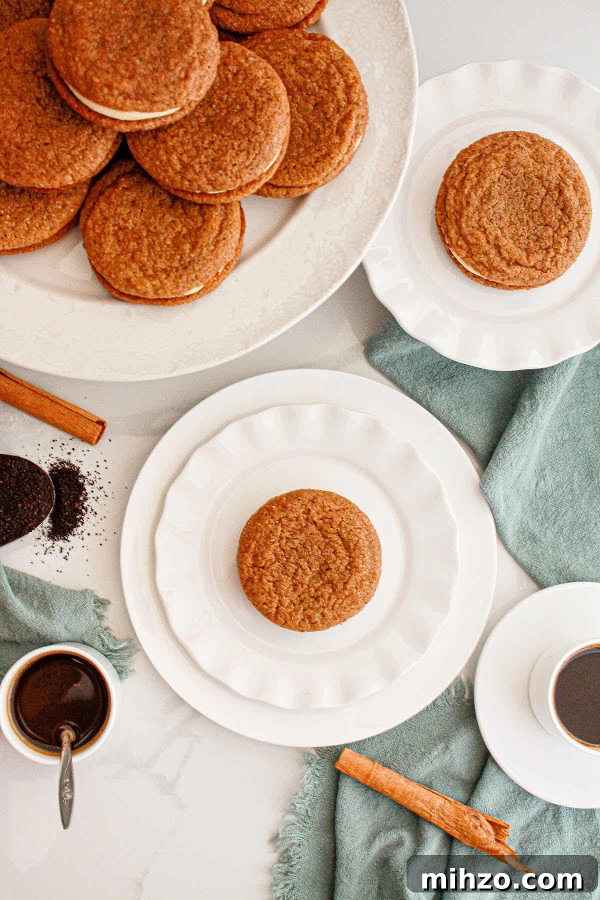 Gingerbread Sandwich Cookies Recipe for the Holidays 10 Top view of white plates with gingerbread sandwich cookies. Green cloth, white surface.