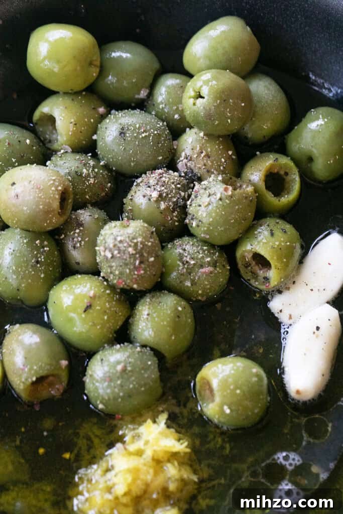 Marinating olives in a skillet.