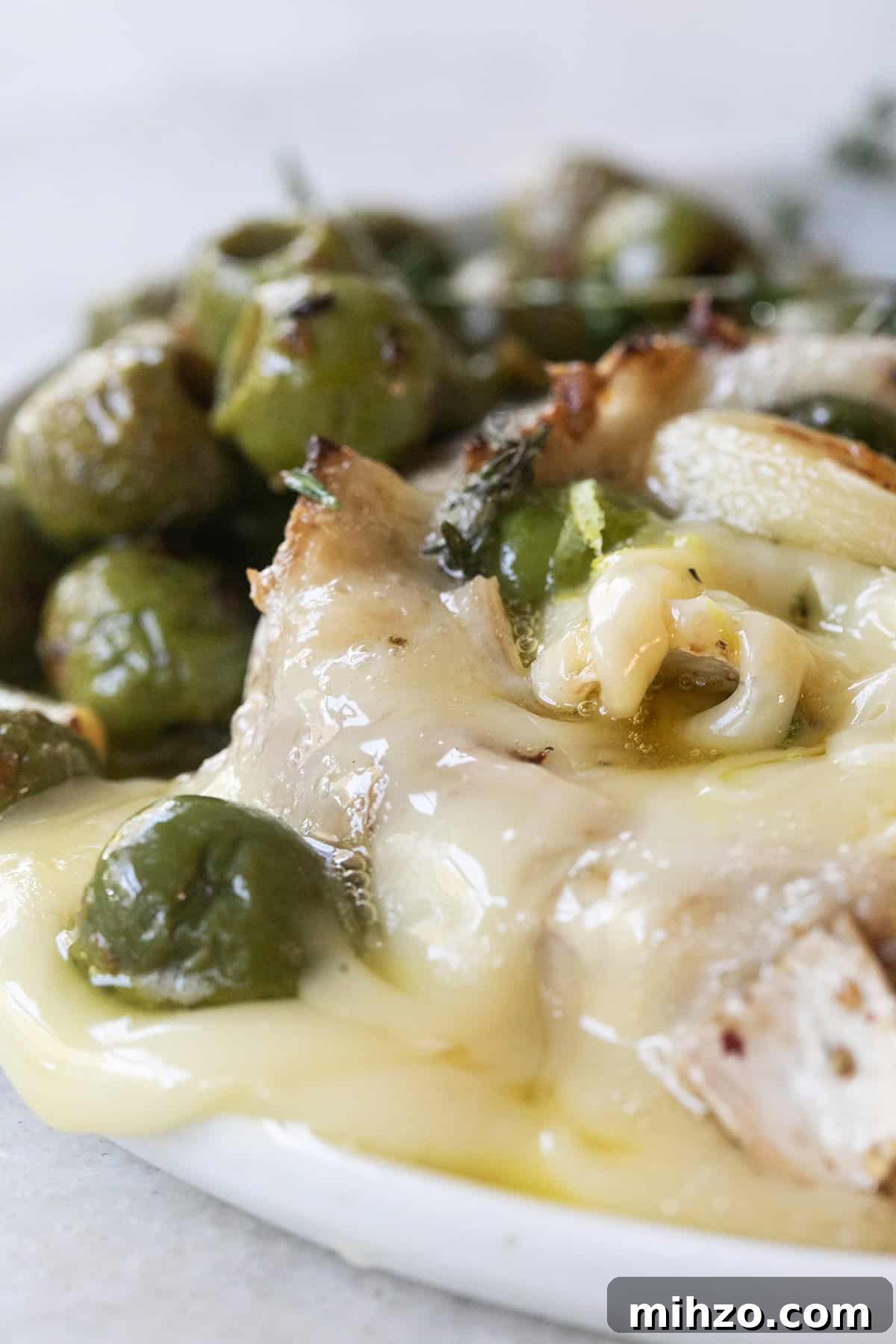 Gooey baked brie recipe with olives and herbs.