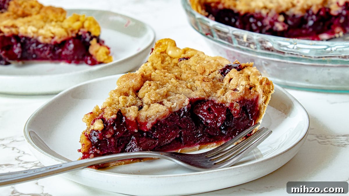 Classic Cherry Crumb Pie with Buttery Streusel Topping 5 cherry crumb pie on a plate with a fork