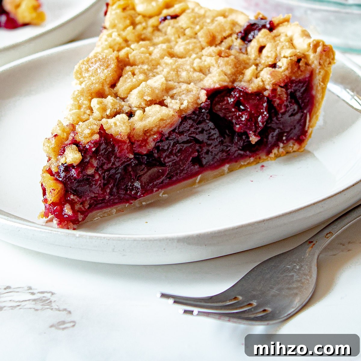 Classic Cherry Crumb Pie with Buttery Streusel Topping 6 cherry crumb pie on a plate
