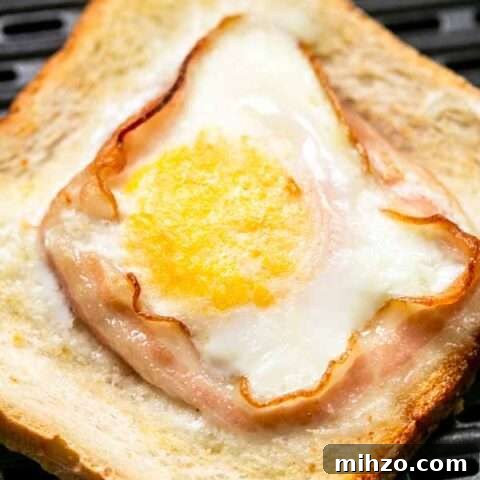 Egg toast with bacon on grill pan in Air Fryer basket