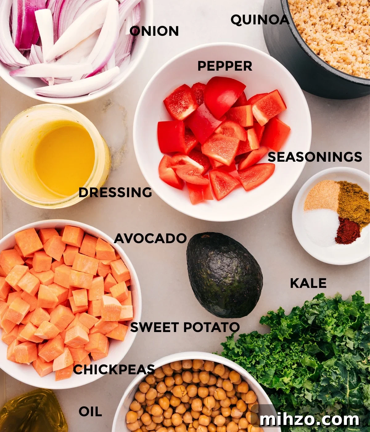 All the ingredients in this recipe are prepped, including veggies, seasonings, quinoa, chickpeas, oil, and dressing.