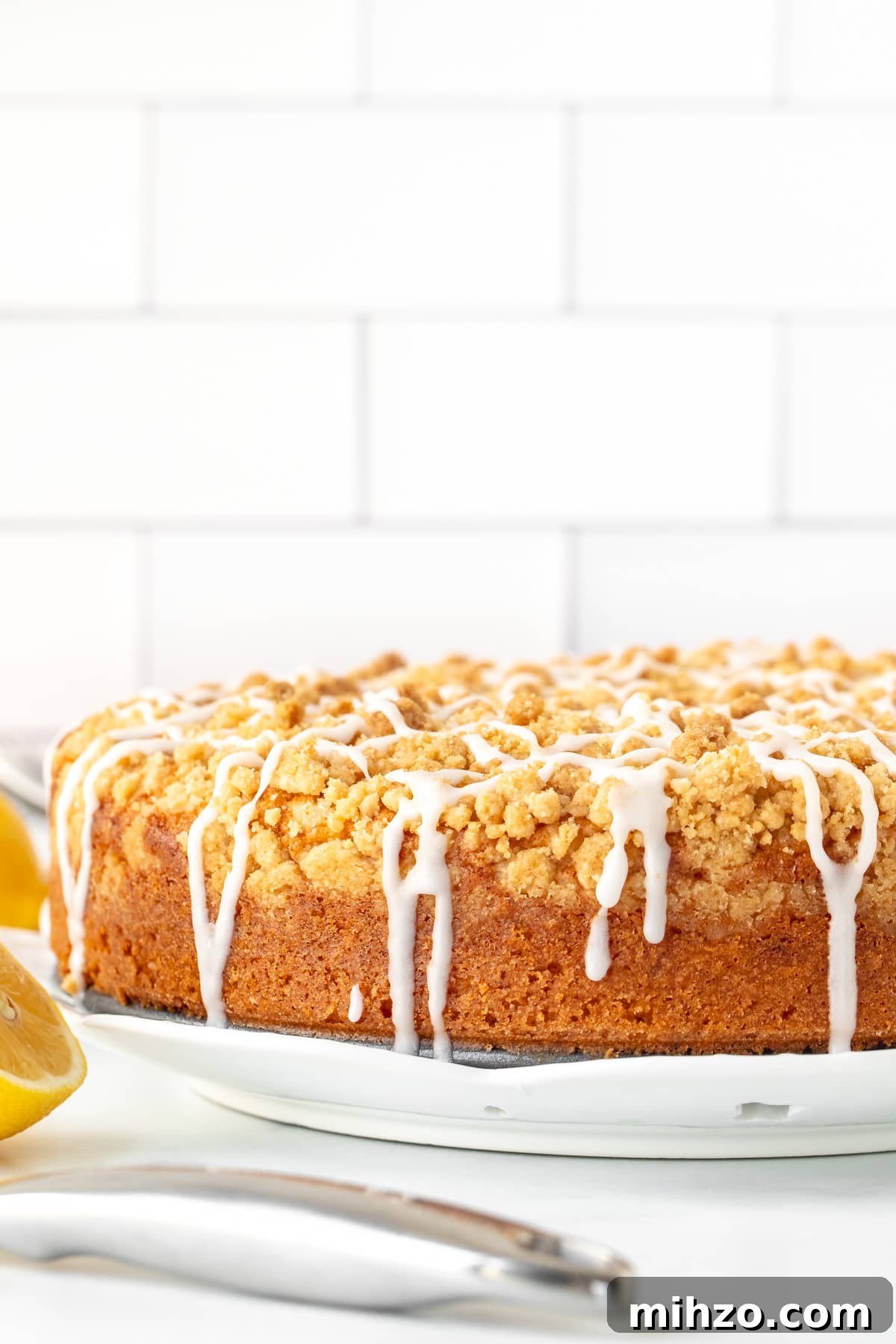 Lemon Coffee Cake Recipe — Moist Citrus Loaf for Brunch 3 9-inch round lemon coffee cake with streusel topping drizzled with glaze