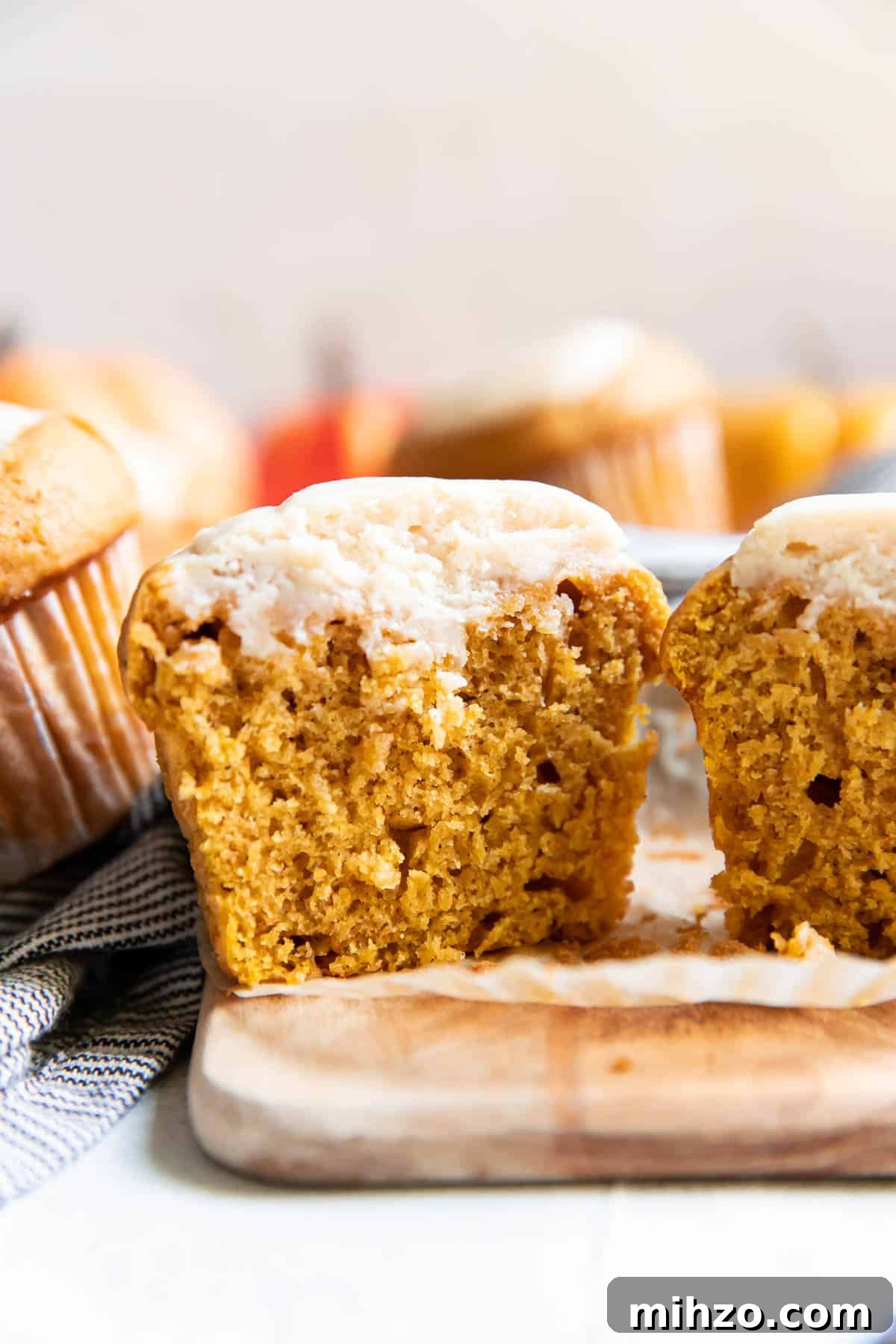Pumpkin Cream Cheese Muffins with Cinnamon Swirl 3 pumpkin cream cheese muffins cut open.