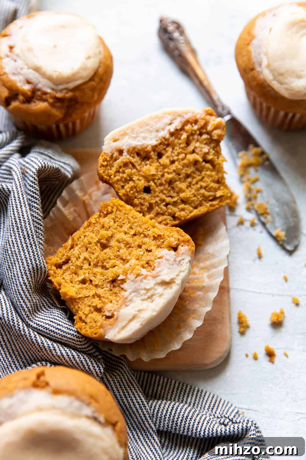 Pumpkin Cream Cheese Muffins with Cinnamon Swirl 9 pumpkin cream cheese muffins cut open.