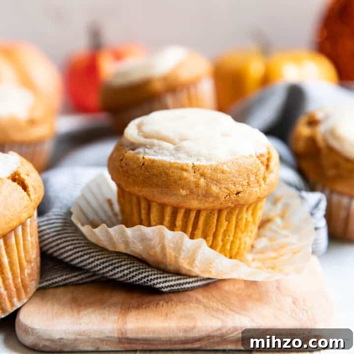 pumpkin cream cheese muffin sitting on it's wrapper.
