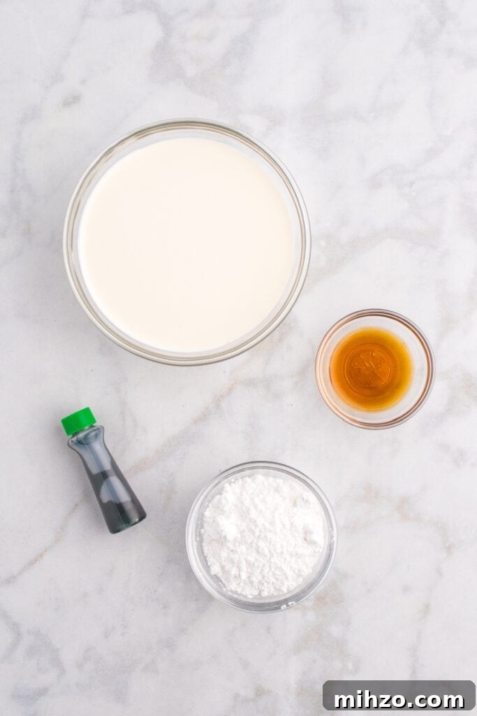 Toxic Waste Punch Recipe: How to Make a Neon Party Drink 4 Bowls of heavy cream, powdered sugar, vanilla extract, and green food coloring arranged on a marble countertop.