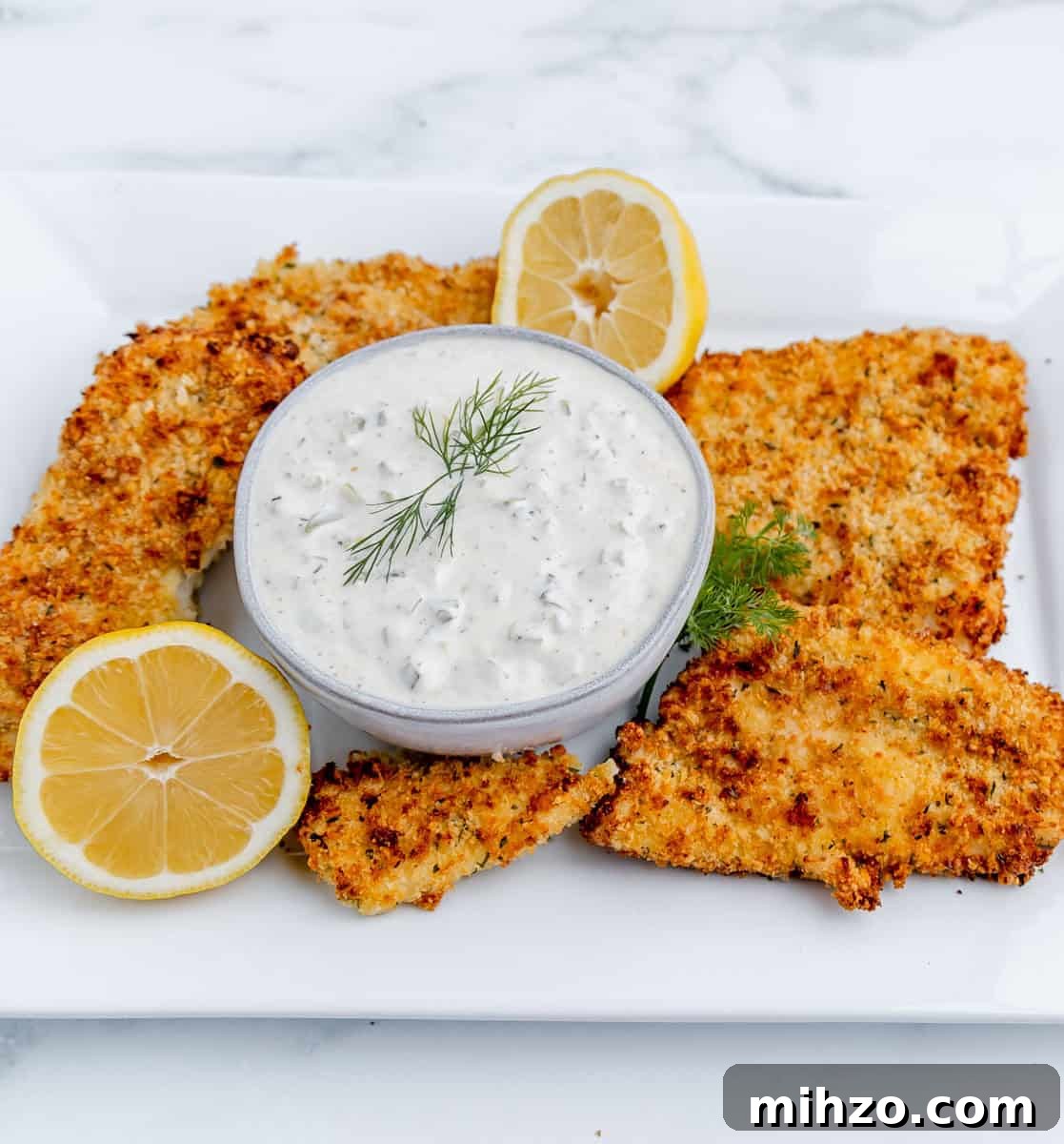 Creamy Homemade Tartar Sauce for Seafood 6 Tartar sauce on a platter with fried fish.