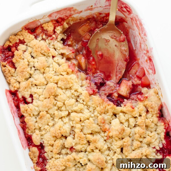 Chocolate-Dipped Apple Slices for Snacks & Parties 16 Plum and apple crumble in a white baking dish with a portion scooped out.