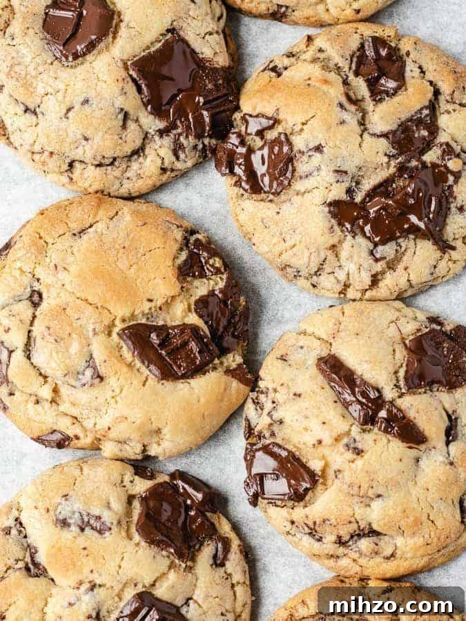 Overhead shot of large chocolate chip cookies with pools of melted dark chocolate