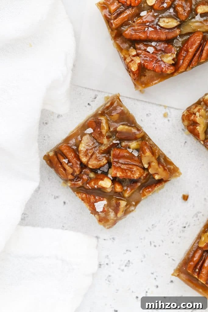 Homemade Caramel Sauce Recipe: Smooth, Pourable & Quick 11 Overhead view of gluten-free salted caramel pecan bars cut into squares