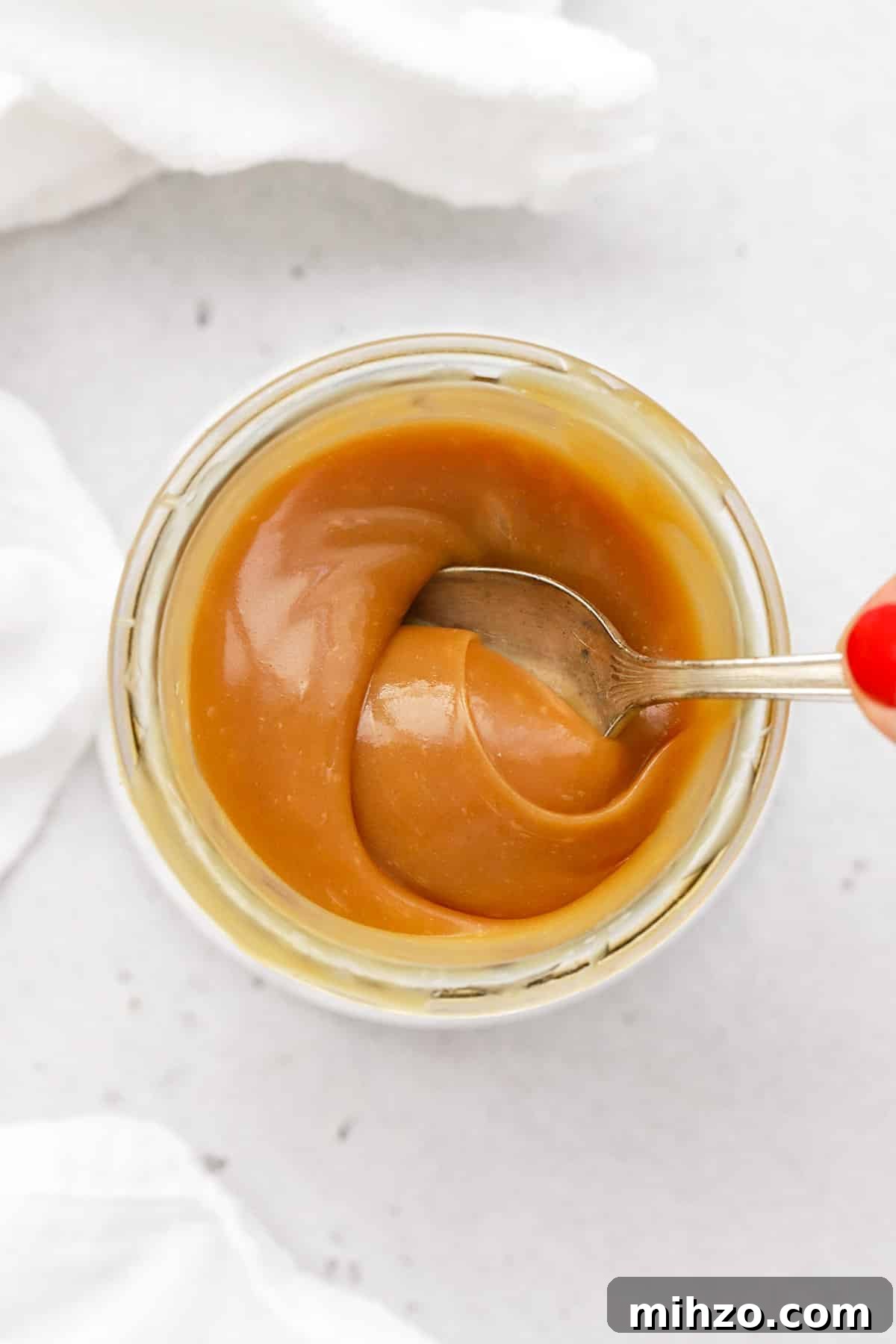 Homemade Caramel Sauce Recipe: Smooth, Pourable & Quick 10 Using a spoon to stir easy homemade caramel sauce
