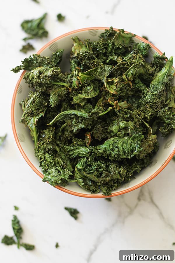 sweet and salty kale chips in a white bowl.