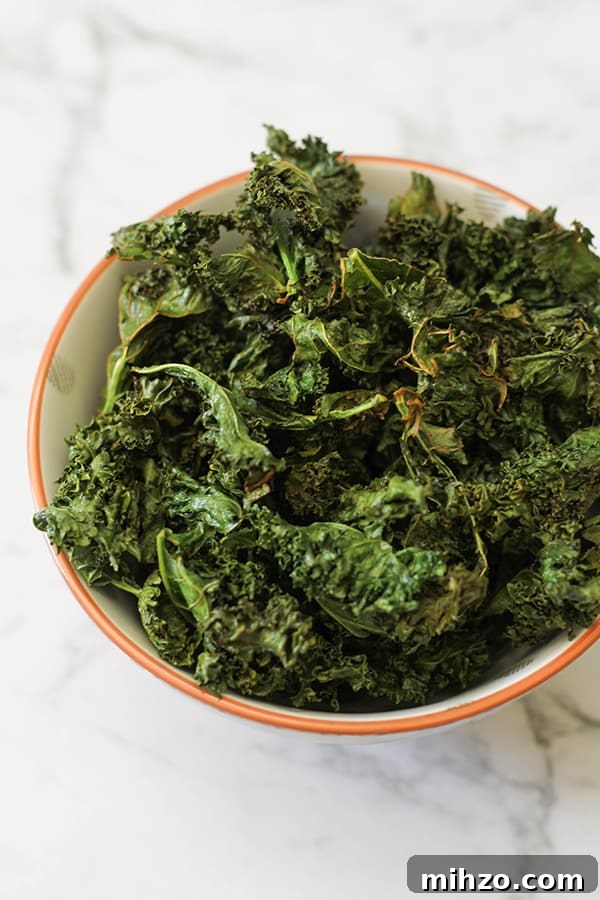 sweet and salty kale chips in a white bowl.