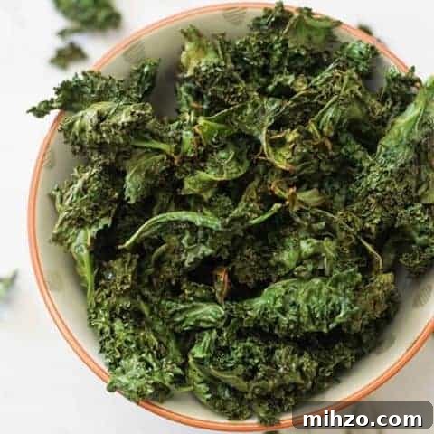 sweet and salty kale chips in a white bowl.
