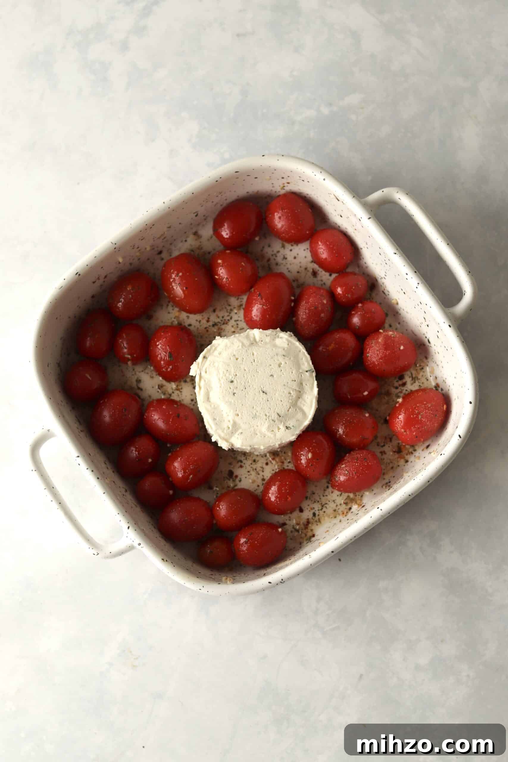 grape tomatoes and Boursin Cheese in baking dish