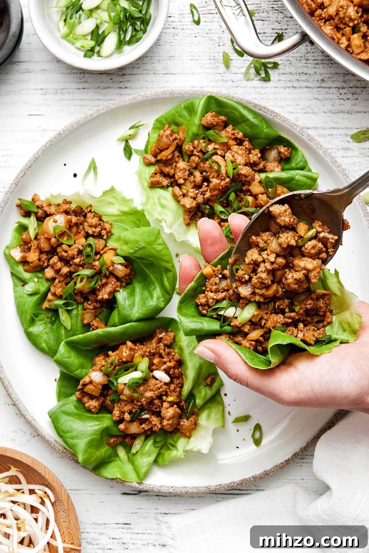 Assembling chicken lettuce wraps.