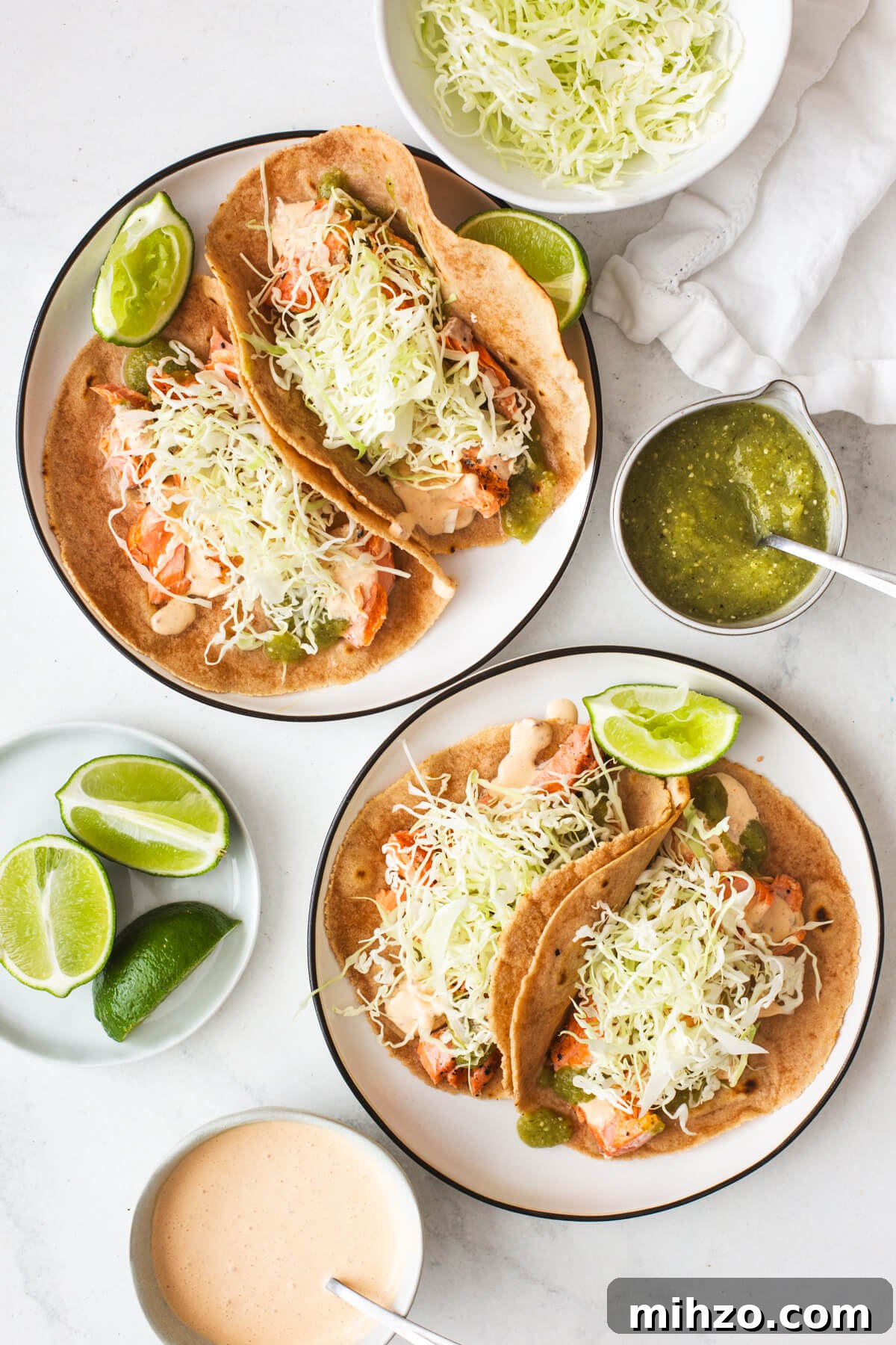 Grilled salmon tacos on two plates