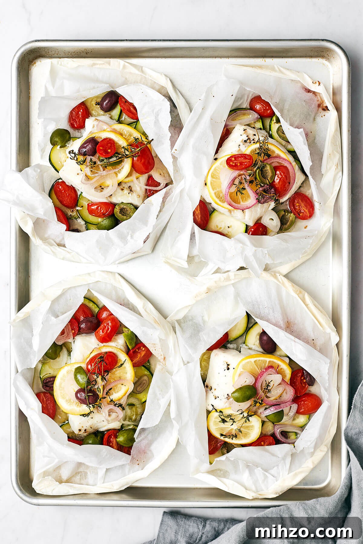 Cods en papillote on a baking sheet